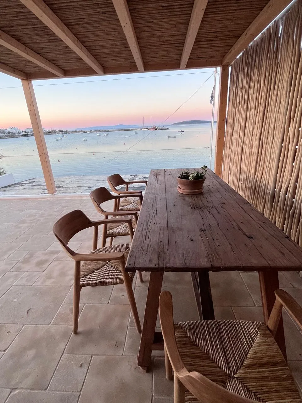 Outdoor dining table at sunset with pastel sky