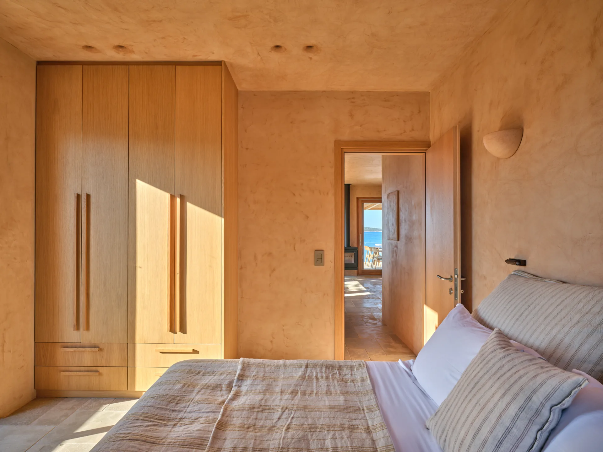 Bedroom wardrobes with sea view through the doorway
