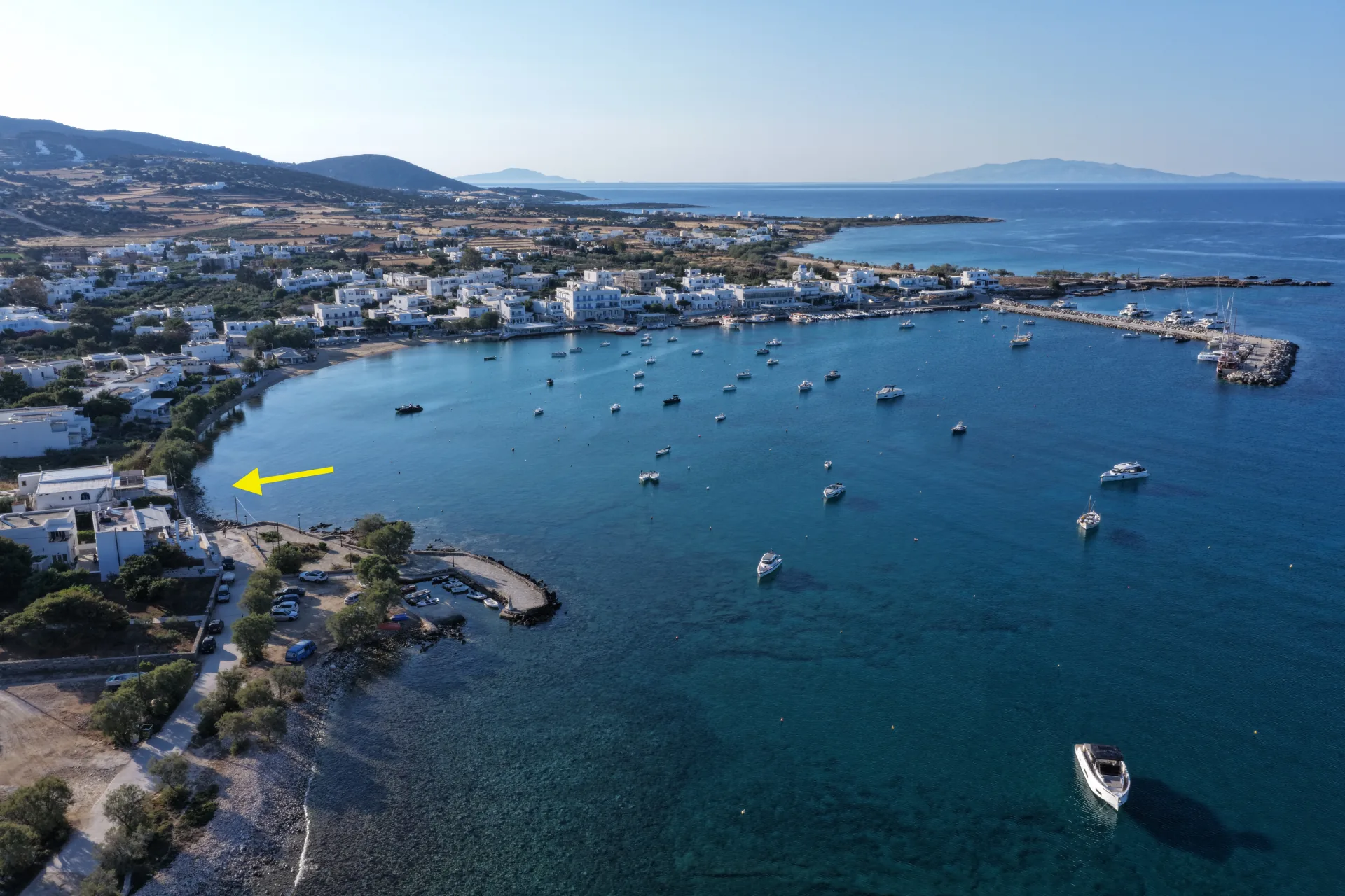 Wide aerial view of Aliki bay and village with The SeaTree marked