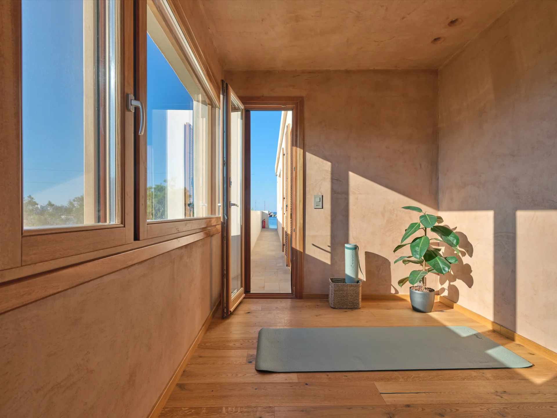 Yoga room mat with doorway to the sea view